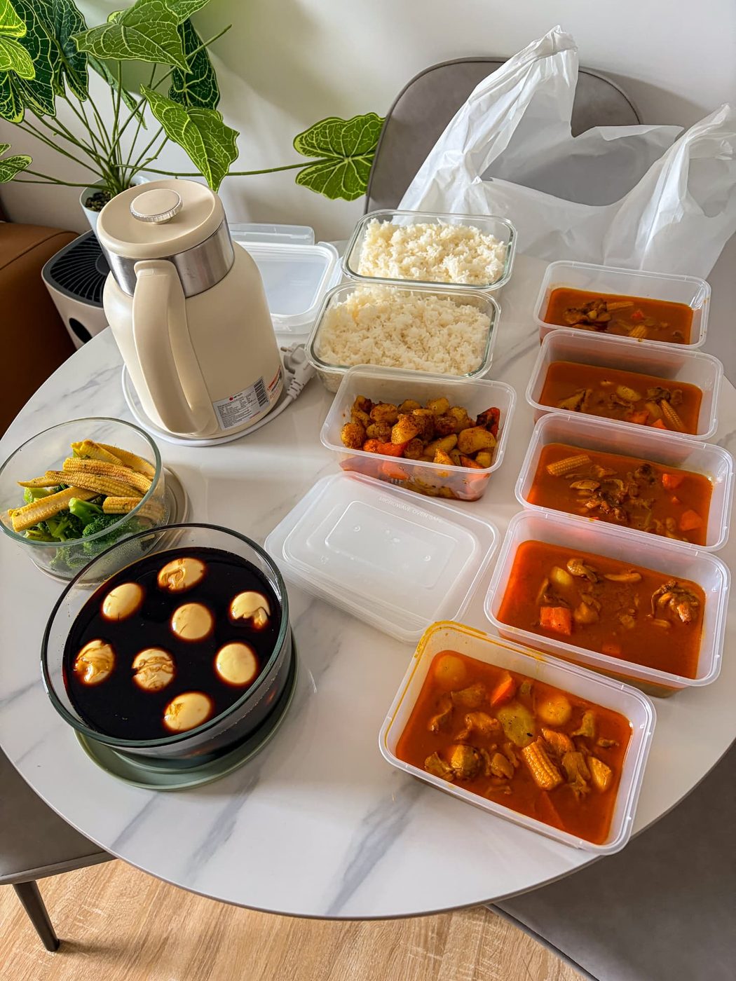 A week's worth of homemade meal prep containers on the kitchen table